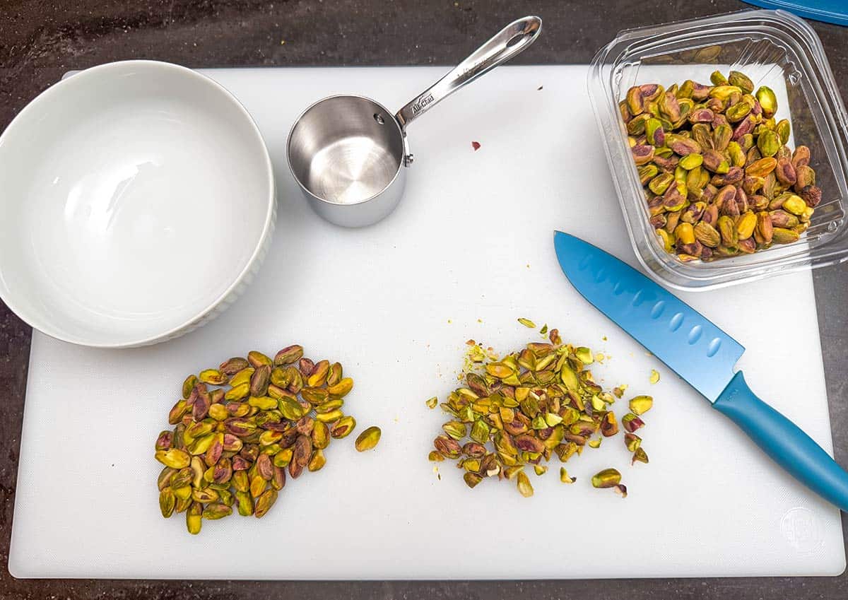 Rough chopping pistachios on a cutting board
