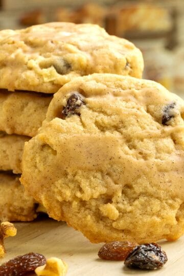 The front view of one of the cookies leaning against a stack of Apple Cider cookies.