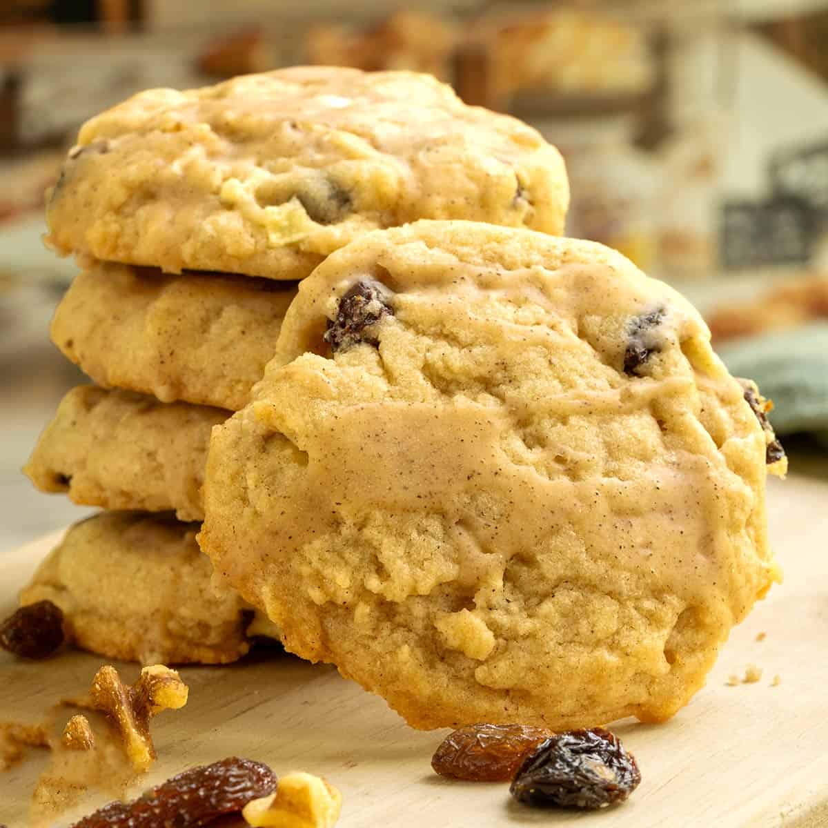 The front view of one of the cookies leaning against a stack of Apple Cider cookies.