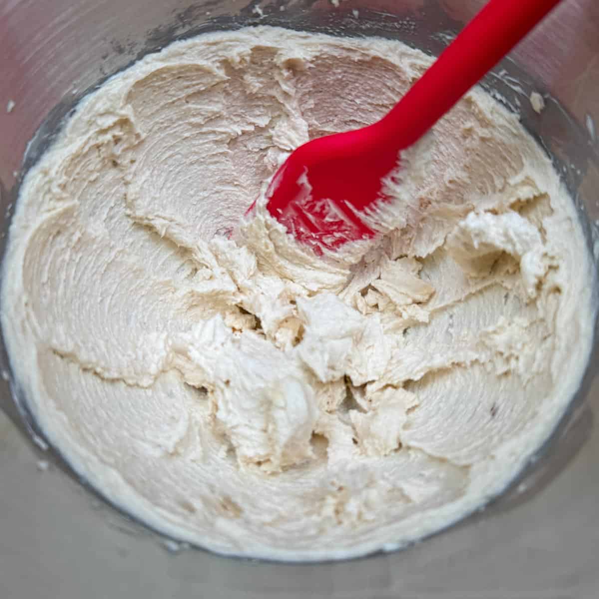 Adding both to the creamed butter and mixing.