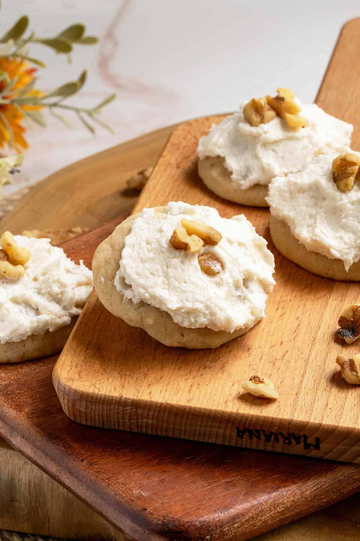 My Applesauce and Walnut Cookies on a cutting board with chopped walnuts laying around them.