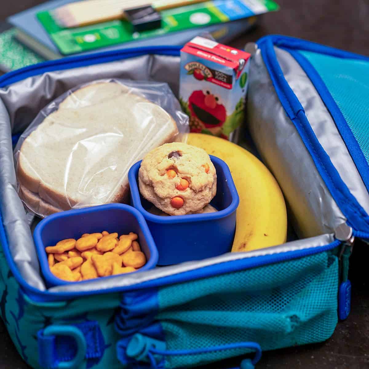 Kids lunchbox filled with all goodies including Peanut Butter M&M and Reese's Pieces Cookies.