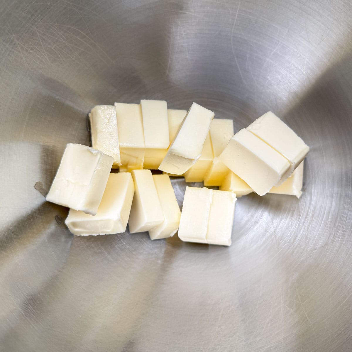 Cubed butter in a mixer bowl.