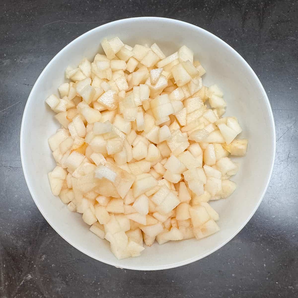 Cut up pears in a bowl.