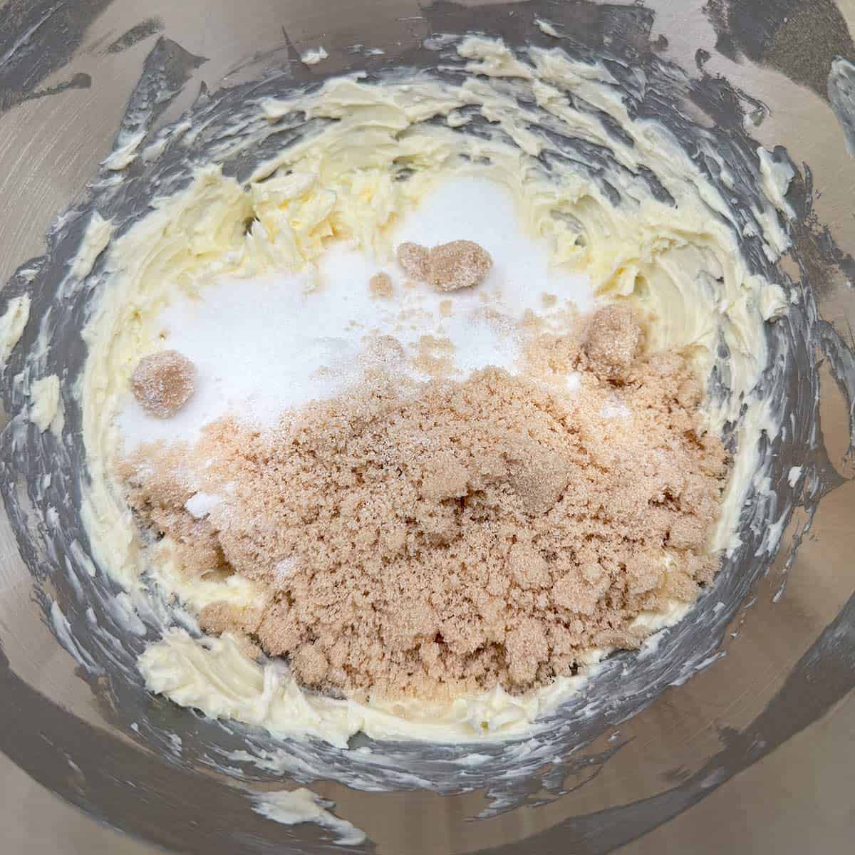 Adding both sugars to the creamed butter.