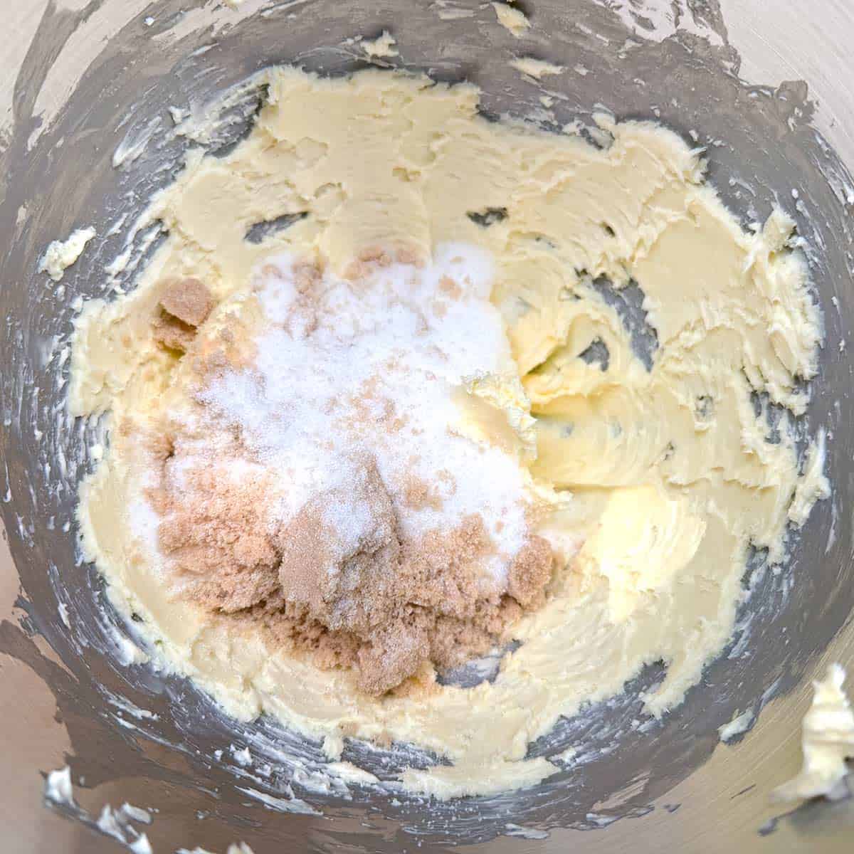Both sugars being added to the creamed butter.