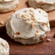 Caramel Apple Cookies with Peanuts sitting on a wooden cutting board.