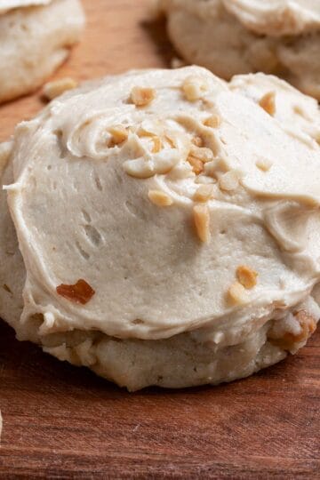 Caramel Apple Cookies with Peanuts sitting on a wooden cutting board.
