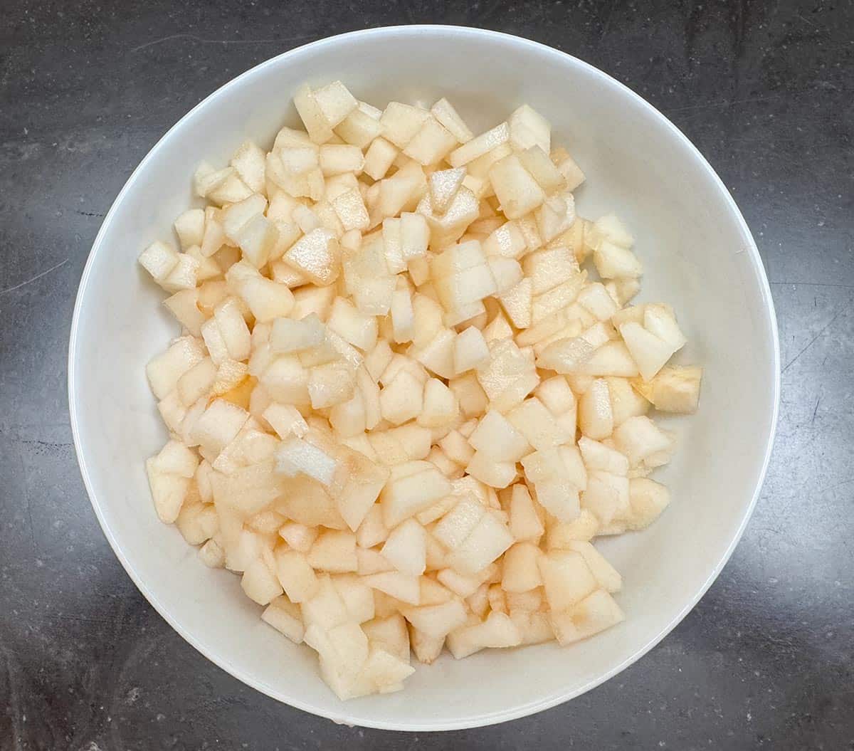 All three pears cut up and in a bowl.