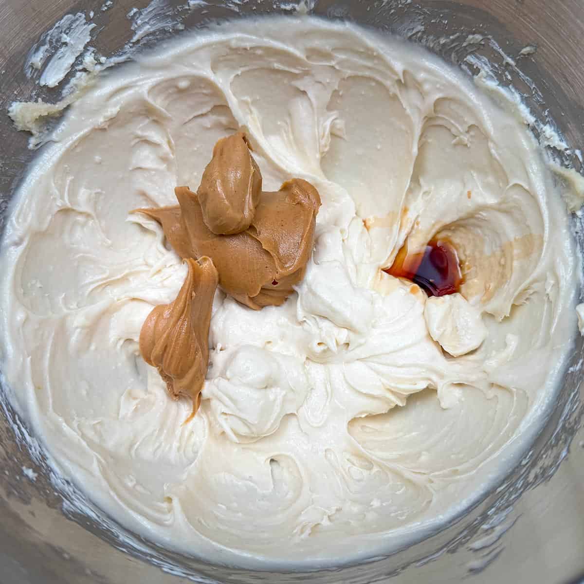 Adding the peanut butter and vanilla to the sugar-butter mixture.