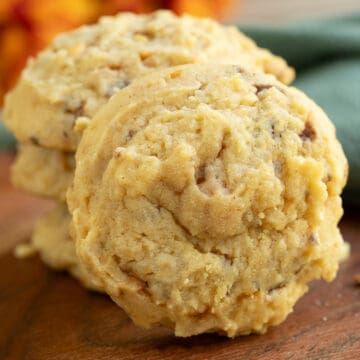 A front look at a Peanut Butter with Butterfinger cookie on a wooden board.