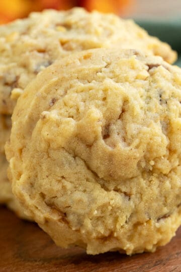 A front look at a Peanut Butter with Butterfinger cookie on a wooden board.