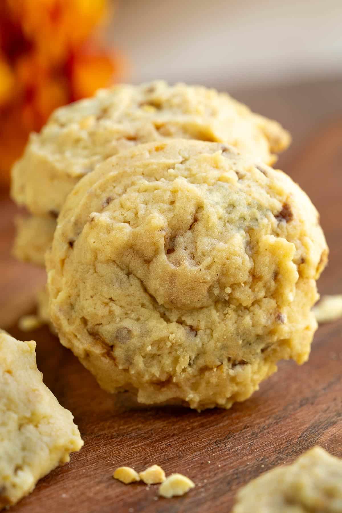 A full front look at a Peanut Butter with Butterfinger cookies on a wooden board.