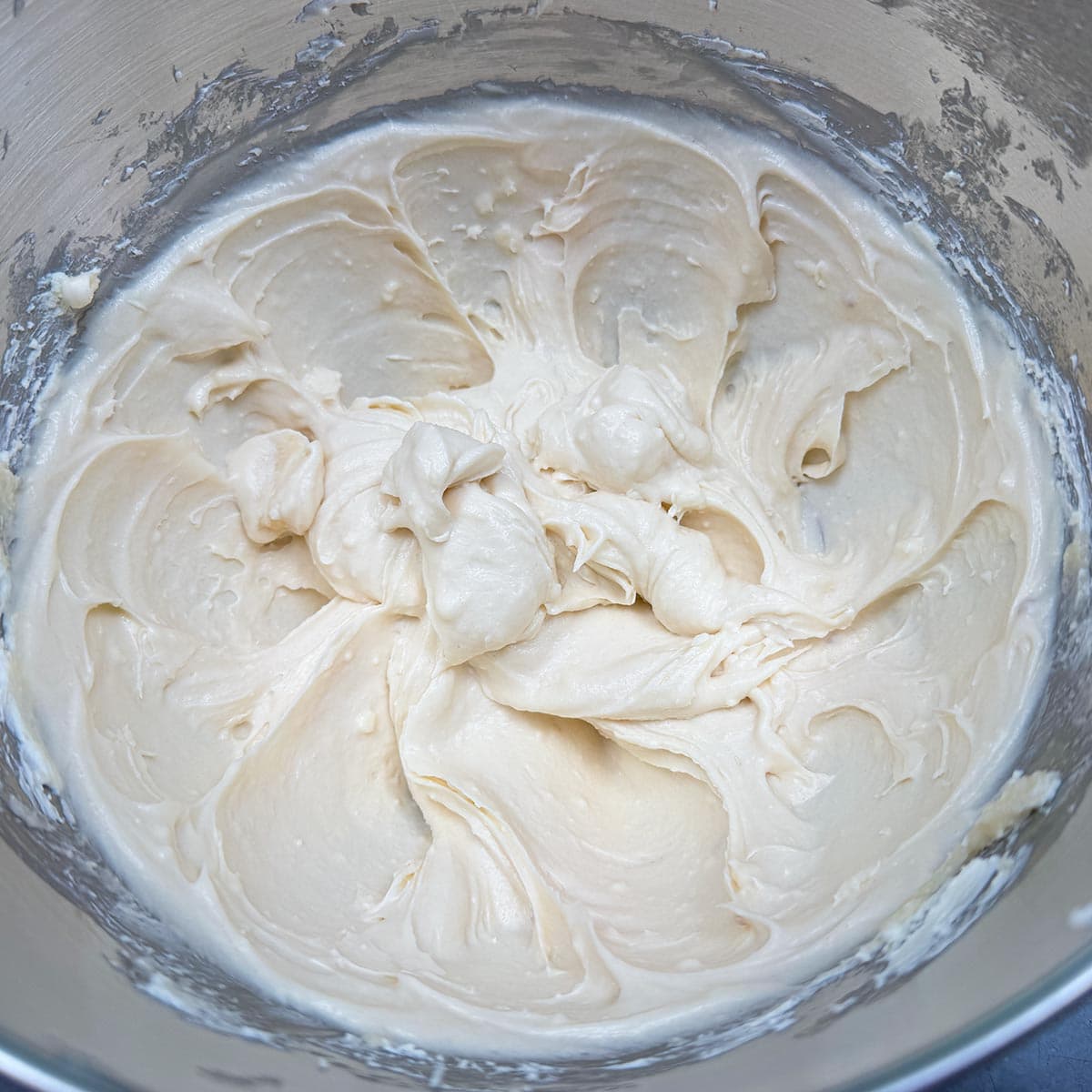 Cream cheese, butter, and both sugars mixed for 3 minutes into soft, creamy mounds in the mixer bowl.