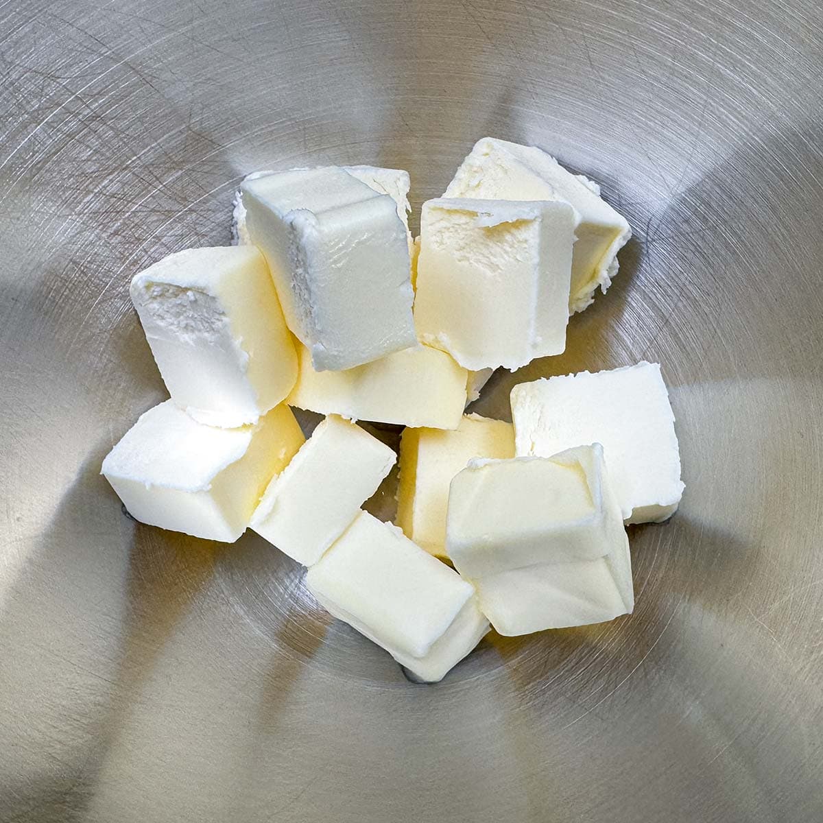 Cubed butter in a mixer bowl.