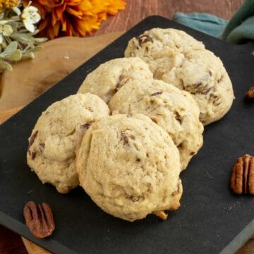 Maple butter pecan cookies on a cutting board with 6 cookies - feature.