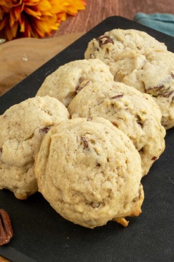 Maple butter pecan cookies on a cutting board with 6 cookies - feature.
