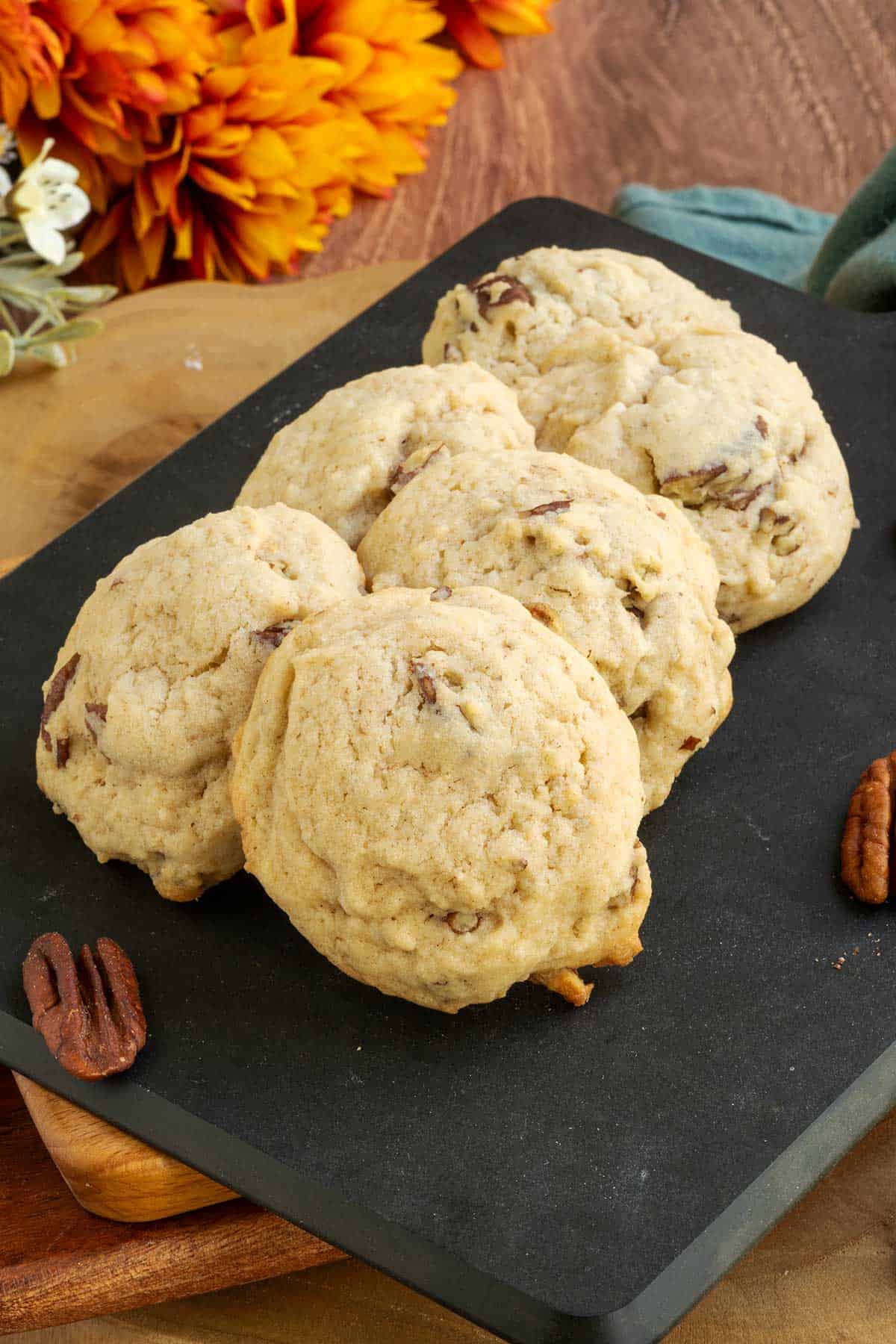 Maple butter pecan cookies on a cutting board with 6 cookies - feature long.