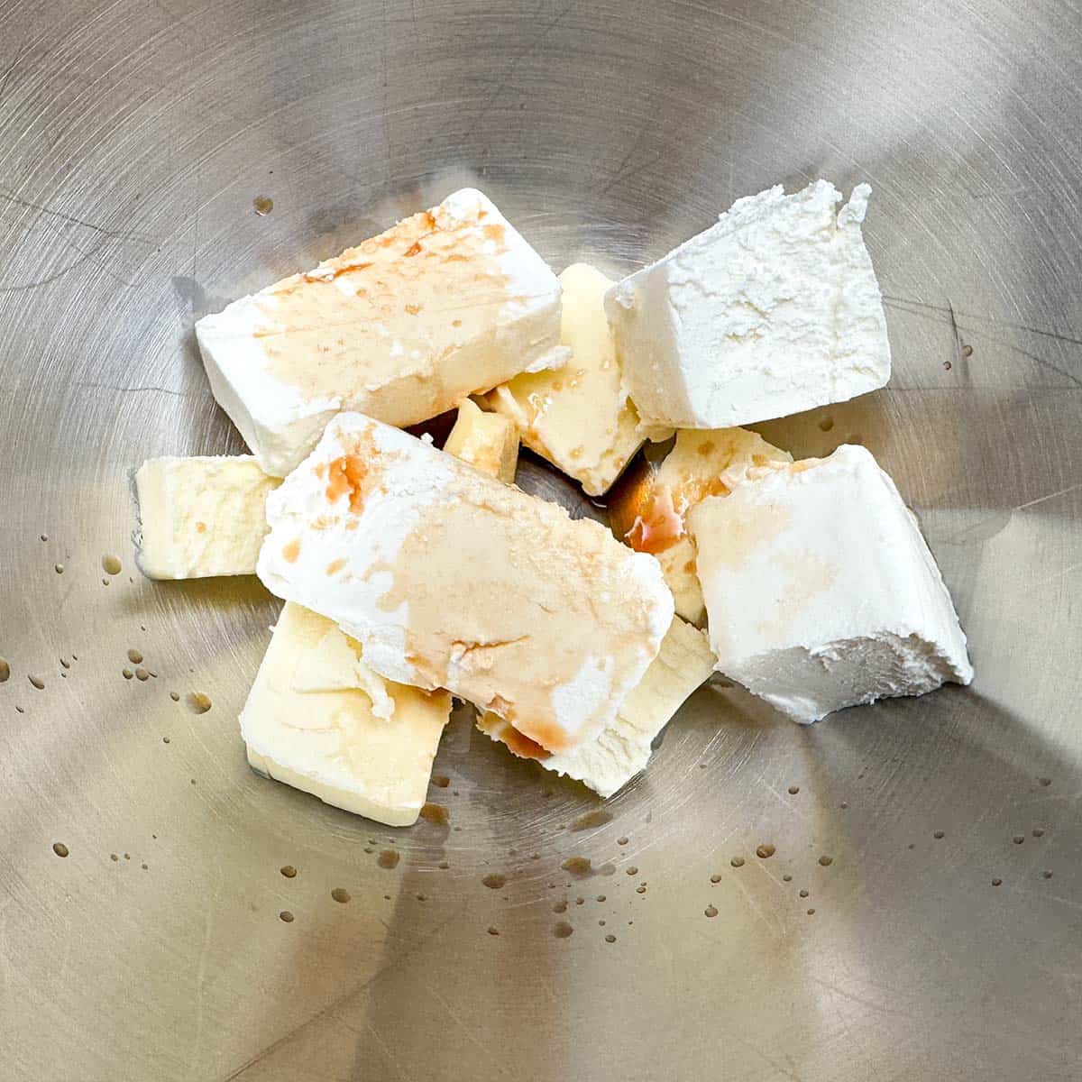 Cubed butter, cream cheese and vanilla extract in a mixer bowl for the icing.
