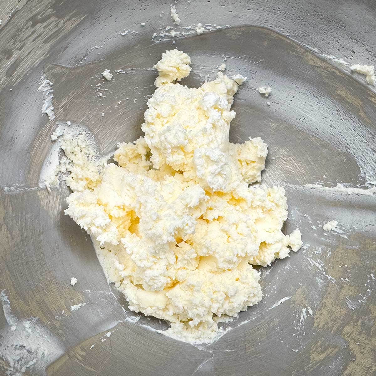Butter and cream cheese mixed in a mixing bowl.
