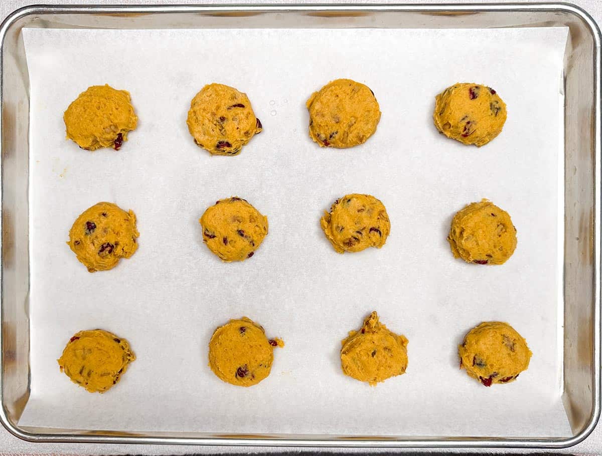 Scooped cookie dough on parchment-lined sheet pan and flatten slightly for the icing.