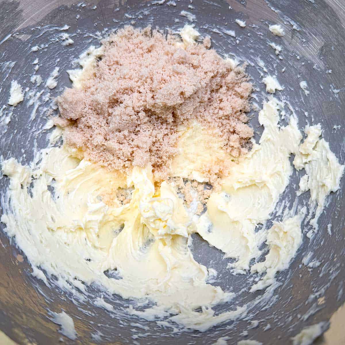 Adding the light brown sugar to the creamed butter.