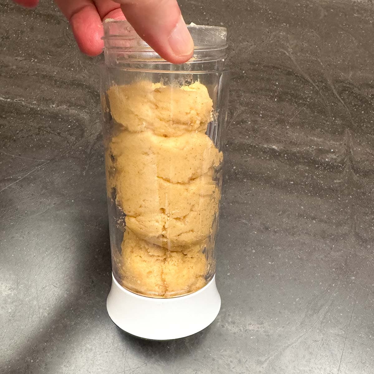 Filling the cylinder with cookie dough.